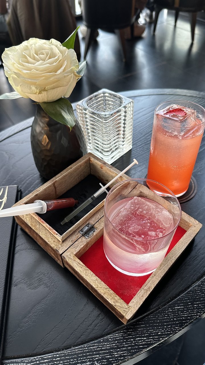 Cocktail and rose flatlay